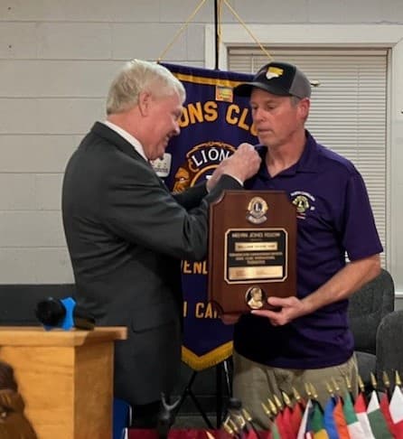 An award recipient holding a plaque, pictured on Wendell Lions Club’s website