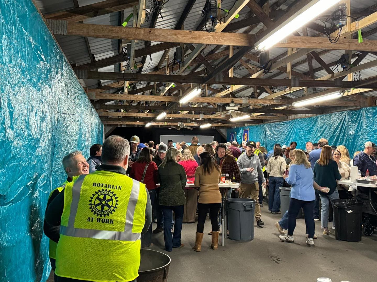 A gathering pictured on the Rotary Club of Wendell membership page, with a volunteer wearing a Rotarian at Work vest
