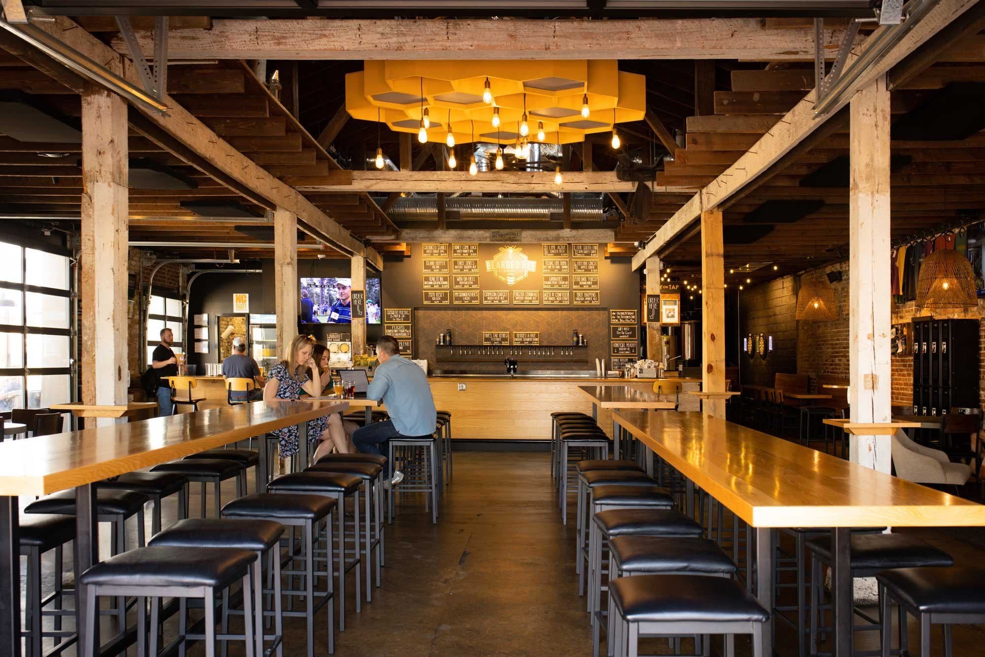 The wood beams, taps and seating inside Bearded Bee’s restored taproom